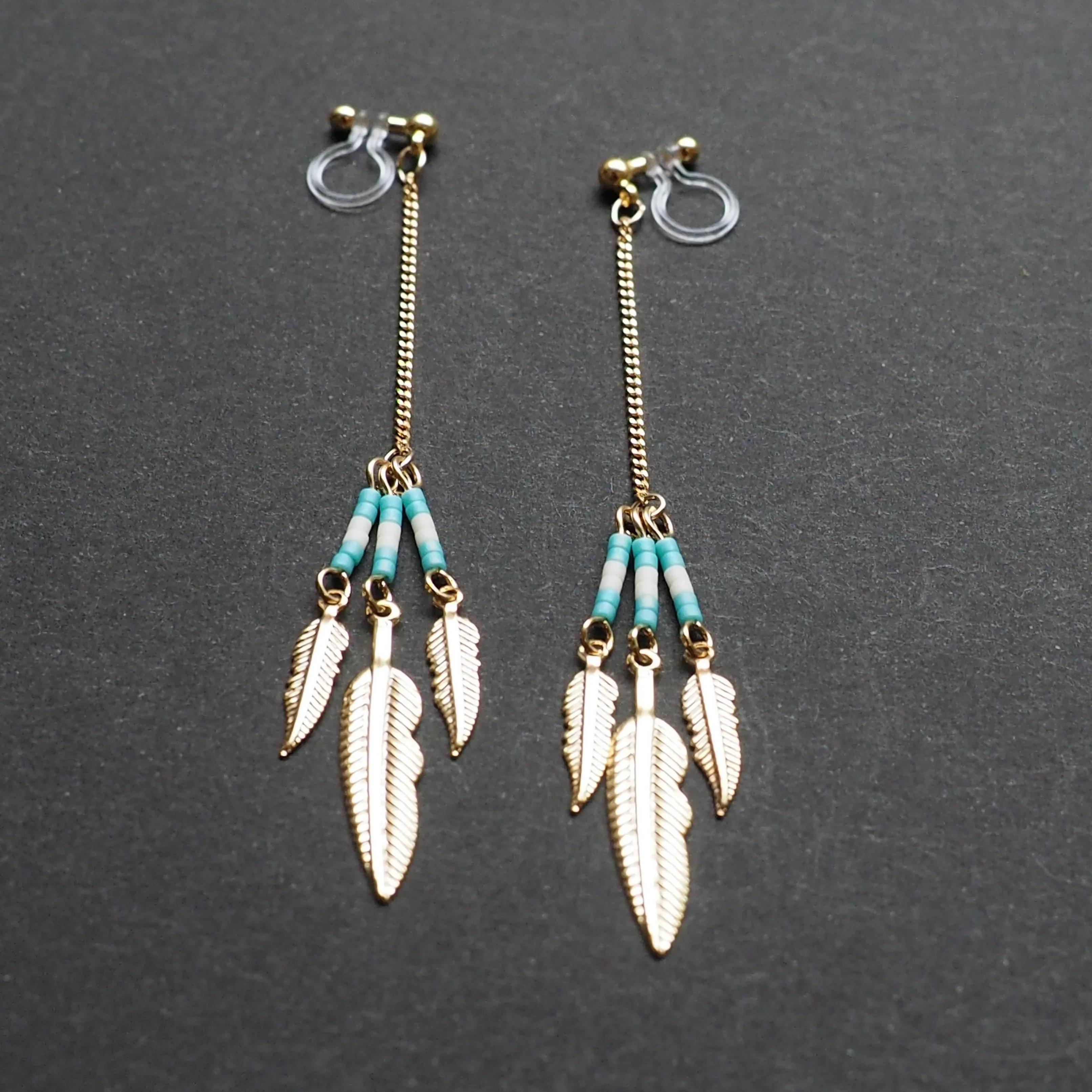 Long feather motif invisible clip on earrings ( Gold tone )