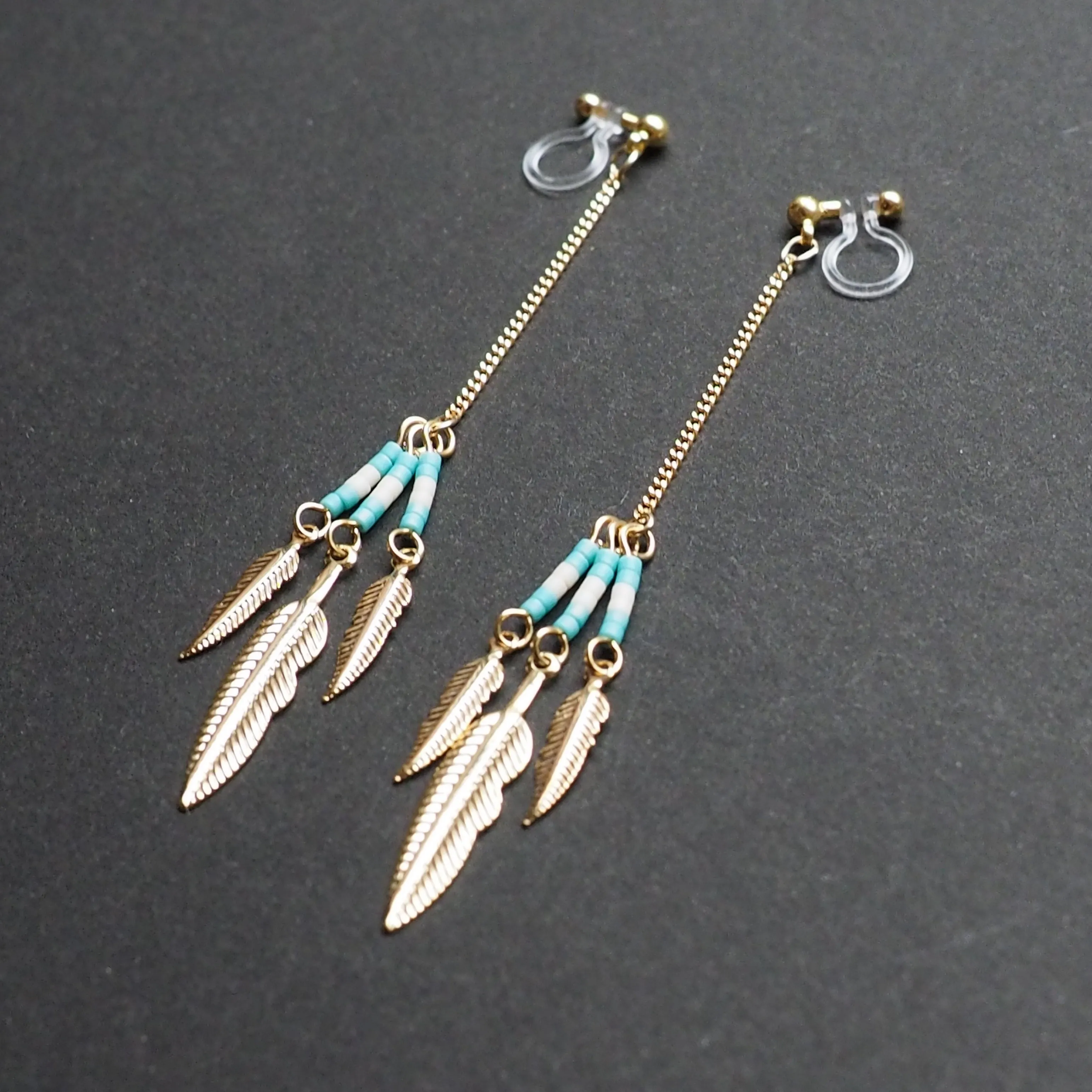 Long feather motif invisible clip on earrings ( Gold tone )