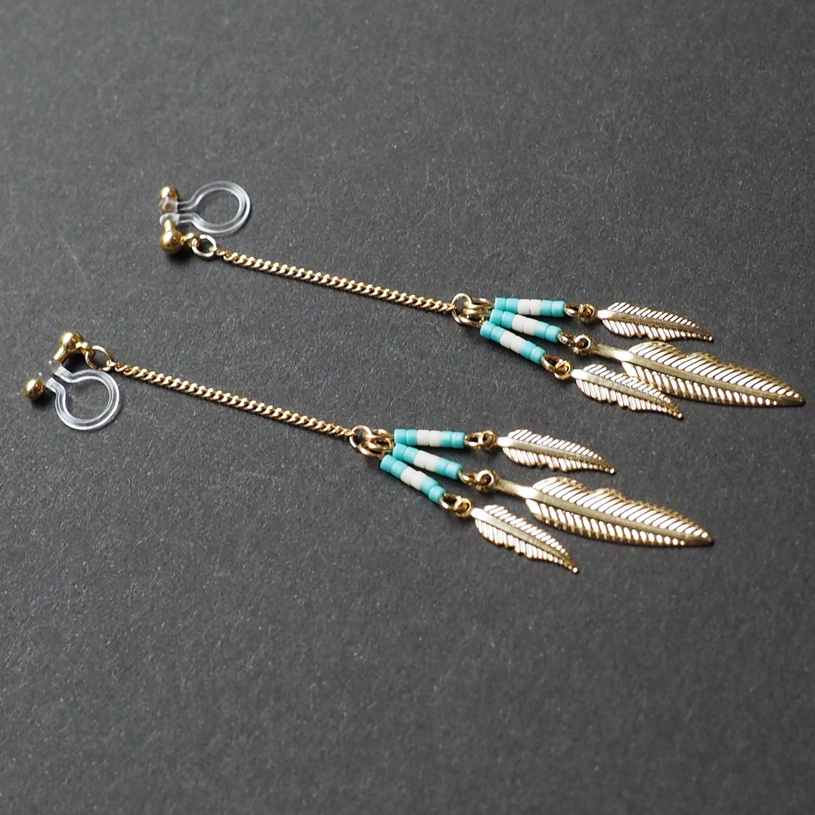 Long feather motif invisible clip on earrings ( Gold tone )